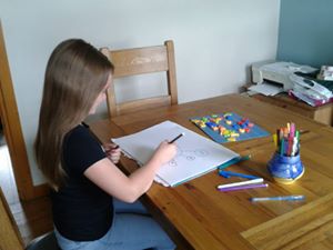 Little girl drawing on paper